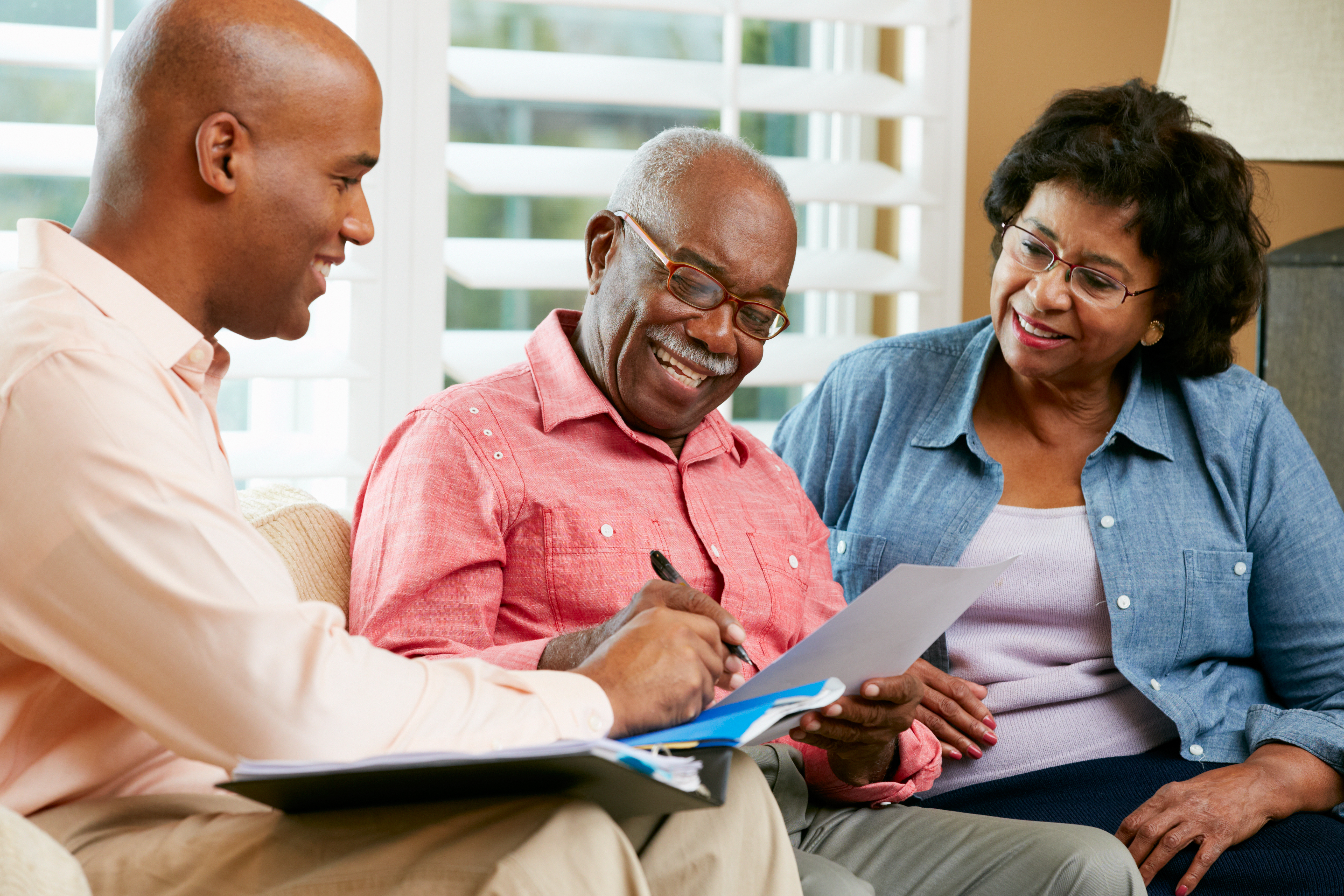 Financial,Advisor,Talking,To,Senior,Couple,At,Home Financial,Advisor,Talking,To,Senior,Couple,At,Home